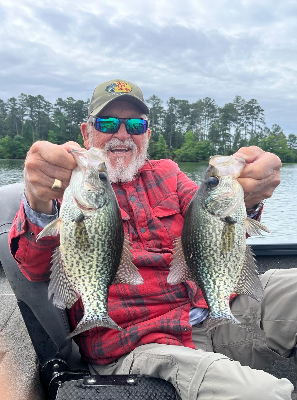 Captain Jim holding two crappie for the featured gallery shot